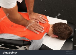stock-photo-a-chiropractor-treating-a-young-boy-222584479   