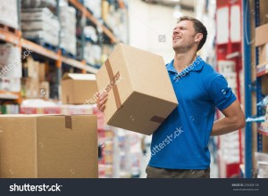 stock-photo-side-view-of-worker-with-backache-while-lifting-box-in-the-warehouse-256008136   